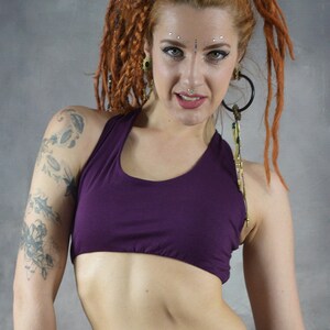 ​Front View (purple): Deep Purple scoop neck yoga bra showing the supportive front fit and sleeveless artisanal design on a model