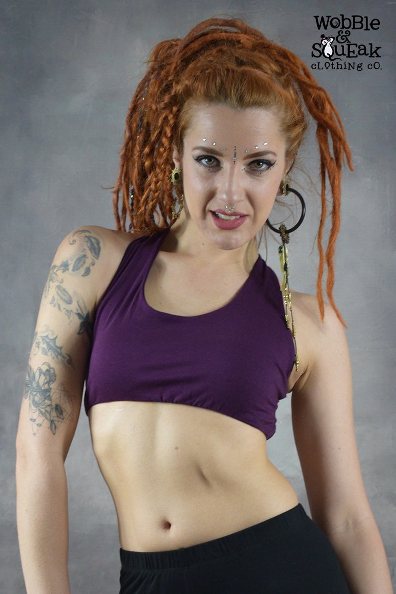 ​Front View (purple): Deep Purple scoop neck yoga bra showing the supportive front fit and sleeveless artisanal design on a model