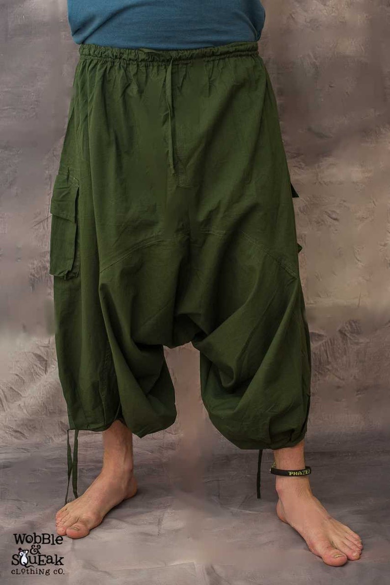 A pair of green cargo trousers with a drawstring waist and a loose, baggy fit. The trousers have two large cargo pockets on the sides and a smaller pocket on the back.