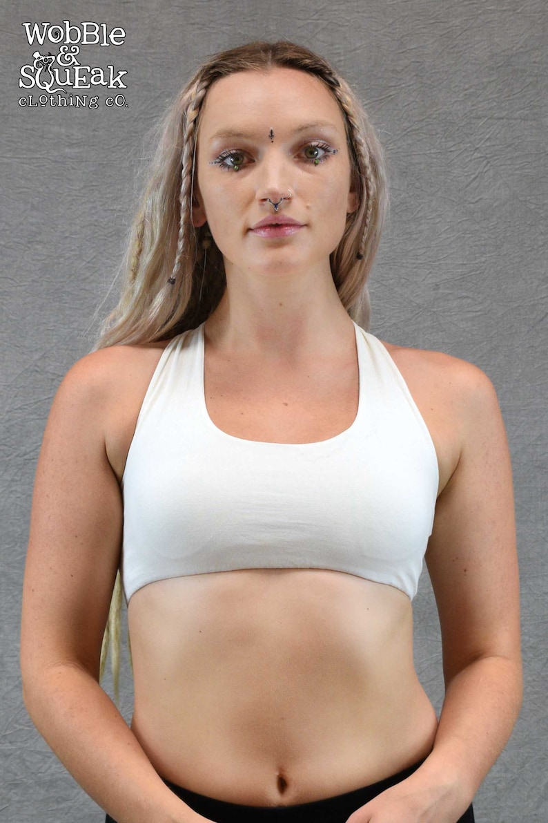 ​Front View off white ): Deep off white scoop neck yoga bra showing the supportive front fit and sleeveless artisanal design on a model