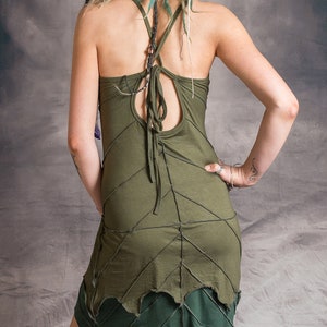 May include: A green sleeveless dress with a criss-cross back and a leaf-shaped hemline.
