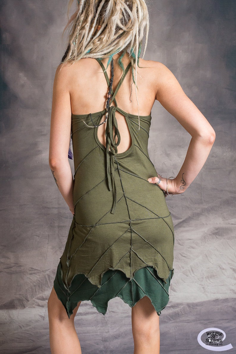 May include: A green sleeveless dress with a criss-cross back and a leaf-shaped hemline.