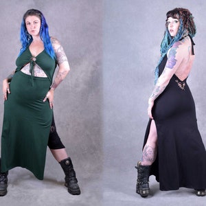Two women wearing long, flowing dresses with side slits. The dress on the left is dark green and the dress on the right is black. Both dresses have a tie detail at the neckline.