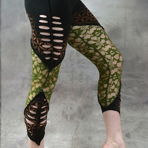 May include: Black leggings with green and brown lace panels. The leggings have cutouts on the sides and a leaf design on the lower leg. The leggings are made by Wobble & Squeak Clothing Co.
