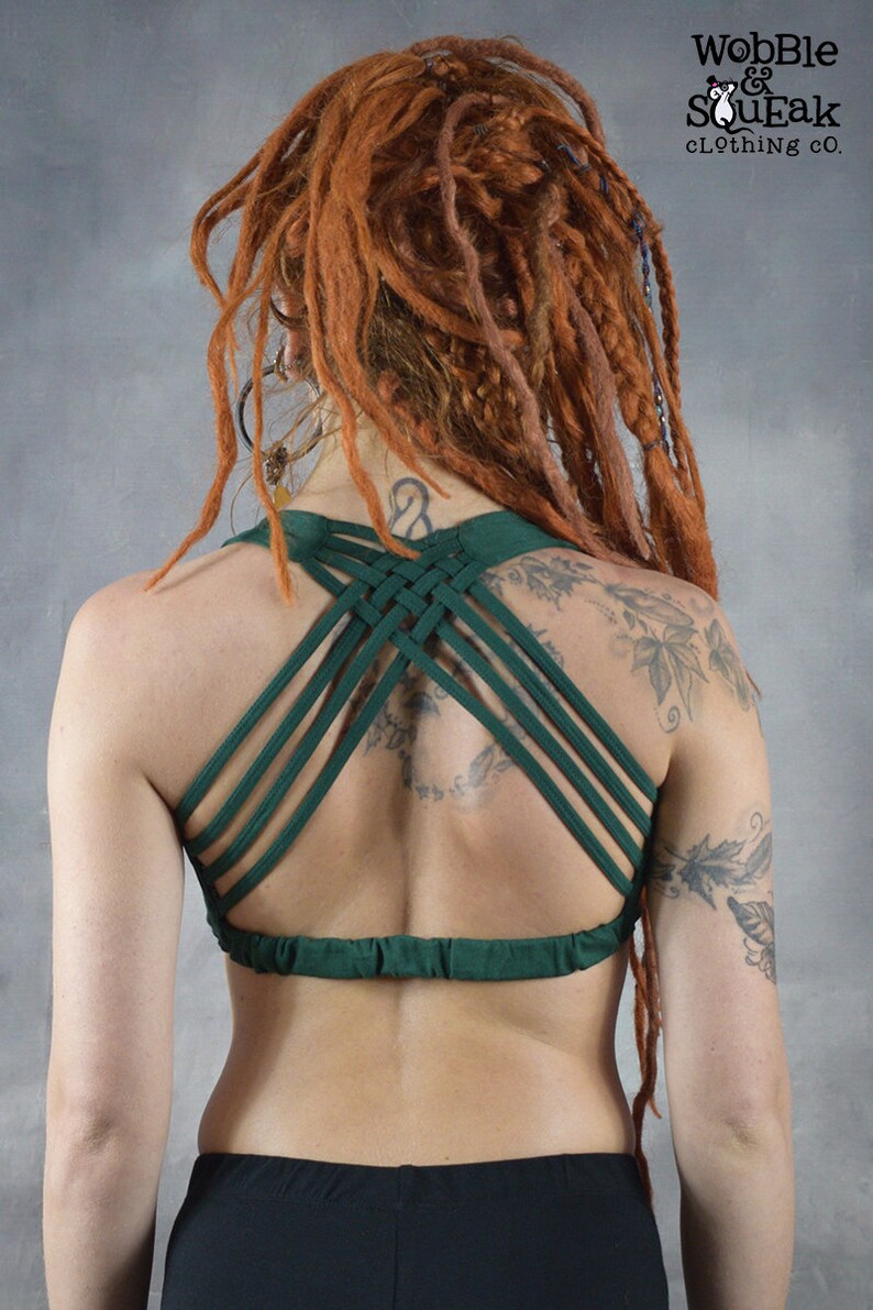 A green criss-cross back sports bra with a gathered band at the bottom. The bra is made of a soft, stretchy fabric and is perfect for yoga, pilates, or other workouts.