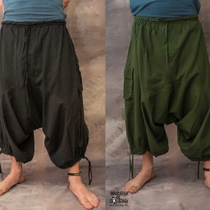 May include: Two pairs of loose-fitting, drawstring trousers with cargo pockets. One pair is black and the other is green.