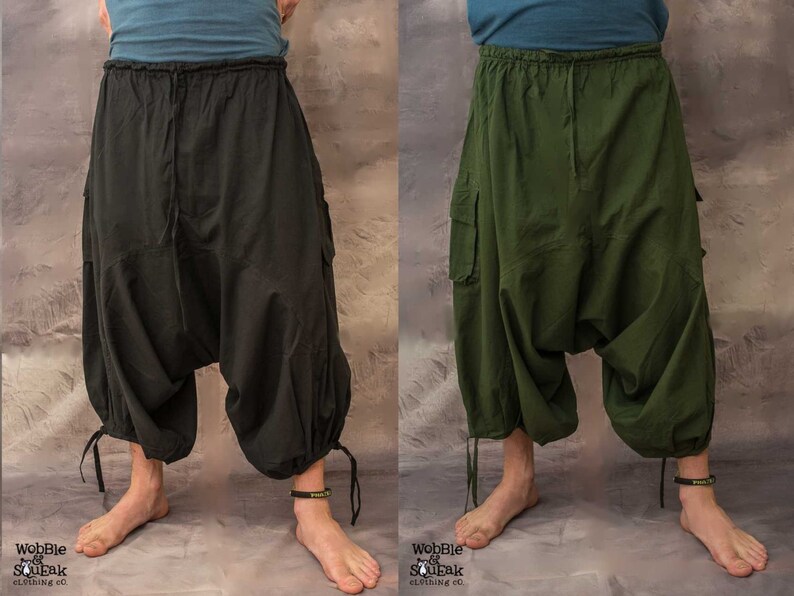 May include: Two pairs of loose-fitting, drawstring trousers with cargo pockets. One pair is black and the other is green.