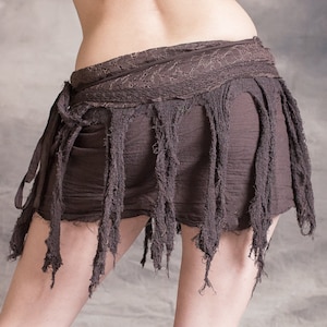 A brown, frayed, and layered skirt with a long, flowing fringe. The skirt is tied at the waist with a thick, brown fabric belt.