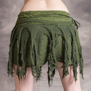 A green, frayed, and layered skirt with a lace waistband. The skirt is made of a soft, flowing fabric and has a bohemian style.
