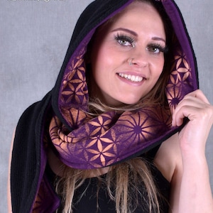 May include: A black hooded scarf with a purple lining and a geometric pattern. The scarf is made of a soft, comfortable fabric and is perfect for keeping warm in the winter.