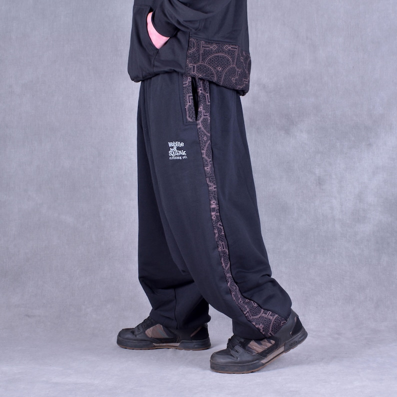 May include: Black sweatpants with a patterned side stripe and the text "Wobble & Soak" printed on the left leg.