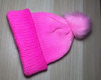 Handmade Beanie, Neon Pink with a fun faux fur pom pom.. 100% Australian superwash wool, This beanie will fit a child or small adult.