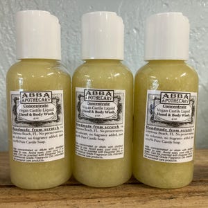 May include: Three amber glass bottles of vegan castile liquid hand and body wash. Each bottle is labeled "ABBA APOTHECARY Concentrate Vegan Castile Liquid Hand & Body Wash 4 oz. Handmade from scratch in Daytona Beach, FL. No preservatives, no colorant, no fragrance added, just 100% Pure Castile Soap."