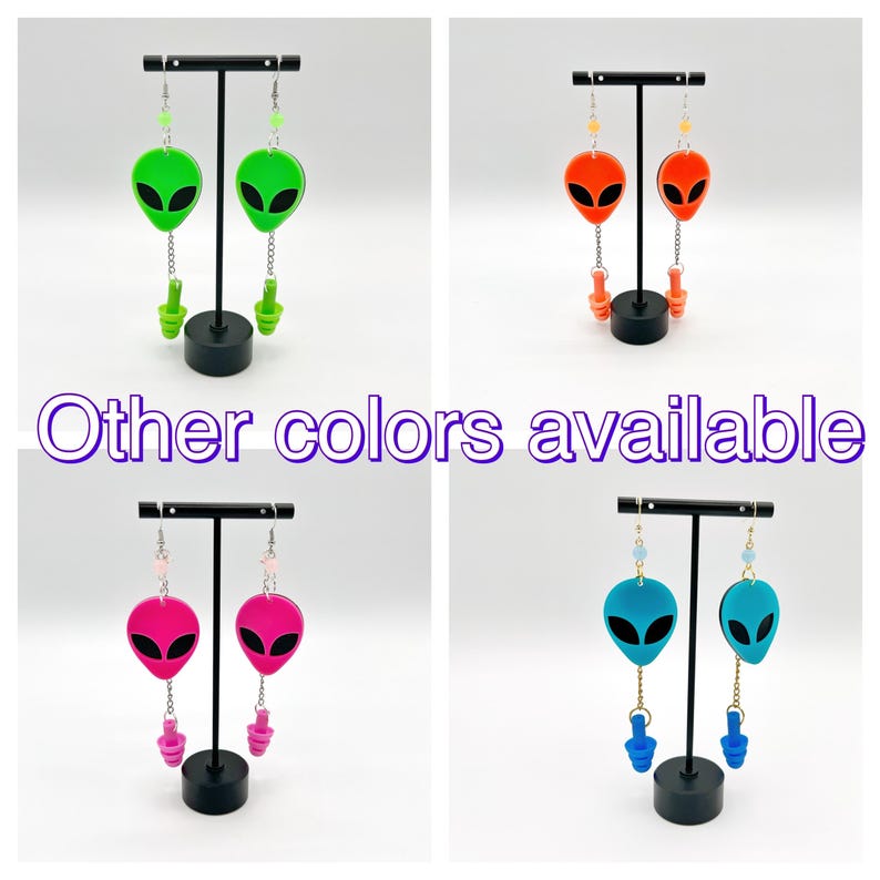 May include: Four pairs of alien-shaped earrings with different colored accents. The earrings are displayed on black stands. The text "Other colors available" is visible in the center of the image.