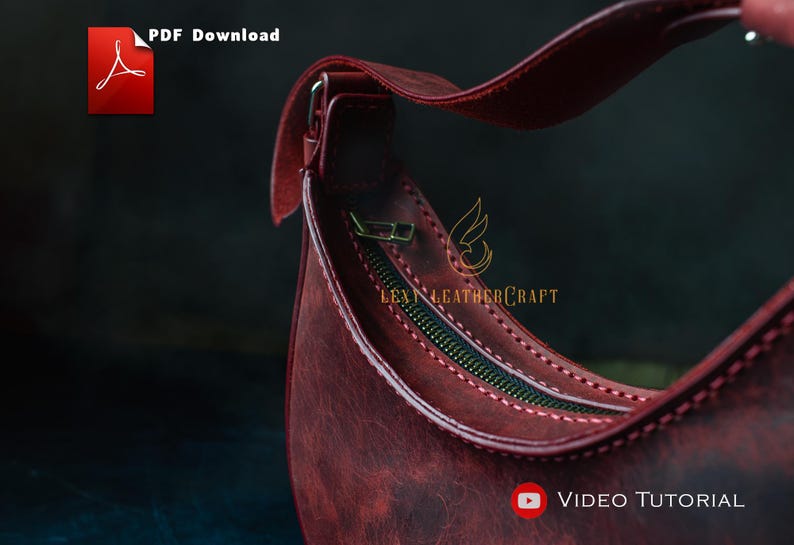 May include: Close-up of a burgundy leather handbag with a curved shape and a zipper closure. The bag has a strap and is stitched with a contrasting thread. The image includes the text "PDF Download" and "Video Tutorial".