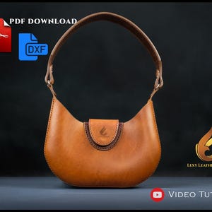 Op de afbeelding: Een bruine leren handtas met een gebogen silhouet, een enkel handvat en een klepsluiting met een klein logo. De afbeelding bevat iconen voor PDF DOWNLOAD, DXF, het Lexy Leather Craft logo en de tekst VIDEO TUTORIAL.