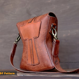 May include: A brown leather crossbody bag with a unique design featuring a stitched-in cross shape. The bag has a long adjustable strap and a metal clasp closure.  PDF Pattern.