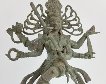 May include: A green bronze statue of a Hindu deity with multiple arms holding various objects. The statue is standing on a black base.