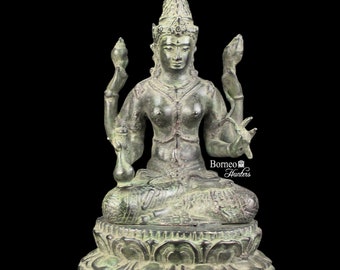 May include: A green bronze statue of a four-armed deity sitting in a meditative pose on a lotus base. The deity has a crown and is adorned with jewelry. The statue is approximately 10 inches tall.
