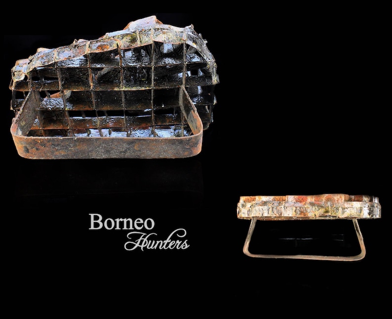 May include: Two rusty metal cages, one with a rectangular shape and the other with a round shape. The cages are made of metal bars and have a rustic appearance. The text "Borneo Hunters" is visible in the image.