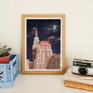 May include: A framed illustration of a city skyline at night with a crescent moon and stars. The tallest building has a red neon sign that reads "NEW YORKER".