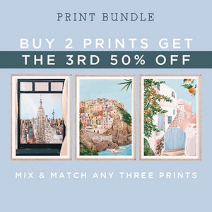 May include: Print bundle featuring three framed art prints. The prints depict a cityscape, a coastal village, and a Mediterranean scene with a blue door and orange trees. The text reads "Buy 2 Prints Get the 3rd 50% Off" and "Mix & Match Any Three Prints."