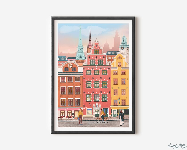 Pode incluir: Uma ilustra&ccedil;&atilde;o colorida de uma cidade com edif&iacute;cios altos de v&aacute;rias cores, incluindo rosa, amarelo e azul. Os edif&iacute;cios t&ecirc;m telhados pontiagudos e janelas. H&aacute; duas pessoas caminhando pela rua, uma com uma bicicleta.