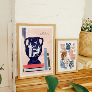 May include: Two framed prints with a pink and blue color scheme. The print on the left features a blue vase with a scene of two figures. The print on the right features a collection of colorful vases.