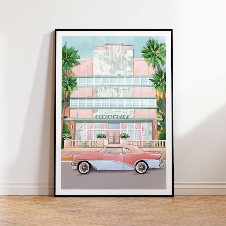 May include: A pink and blue vintage car parked in front of a pastel pink and green art deco building with palm trees. The building has the text "Ocean Plaza" above the entrance.