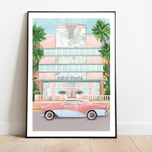 May include: A vintage pink and blue car parked in front of a pastel pink and green art deco building with palm trees. The building has the words "Ocean Plaza" above the entrance.