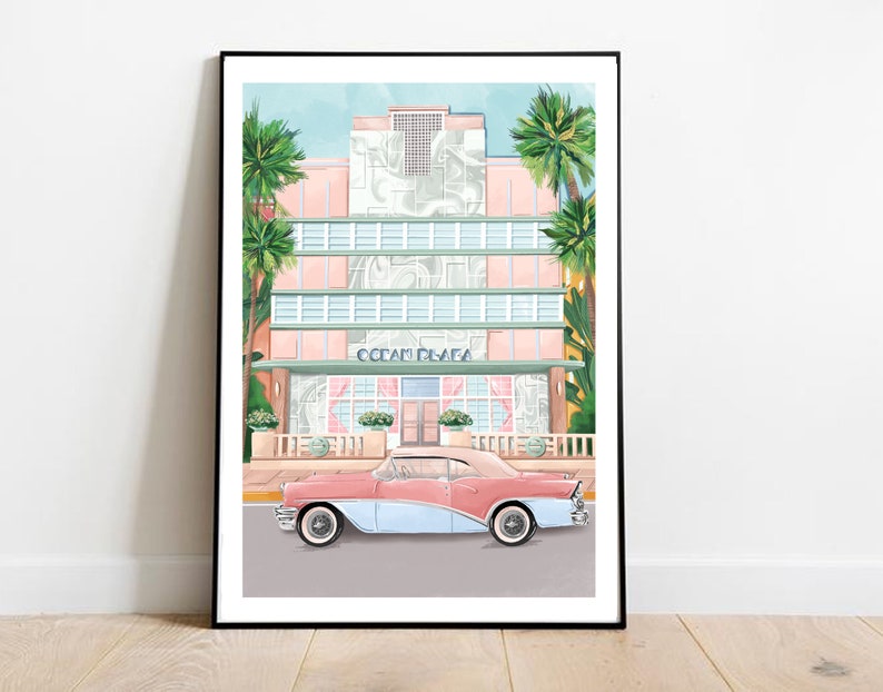 May include: A vintage pink and blue car parked in front of a pastel pink and green art deco building with palm trees. The building has the words "Ocean Plaza" above the entrance.