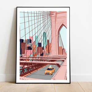 May include: A framed art print depicting the Brooklyn Bridge in New York City. The illustration features a yellow taxi cab on the bridge, with a cityscape in the background. The artwork uses a pastel color palette of pink, blue, and orange.