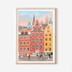 Pode incluir: Uma ilustra&ccedil;&atilde;o colorida de uma cidade com edif&iacute;cios altos e um campan&aacute;rio de igreja. Os edif&iacute;cios s&atilde;o pintados em tons de rosa, amarelo e azul. H&aacute; pessoas caminhando na rua abaixo.