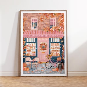 Pode incluir: Uma impressão artística emoldurada retratando uma vitrine com o letreiro PUMPKIN SPICE BAKERY, toldo rosa, fachada de tijolos e folhagem de outono. A cena inclui uma bicicleta rosa, mesas de bistrô, abóboras e uma placa Baked Fresh Daily.