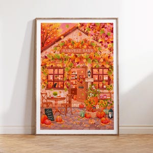 Könnte beinhalten: Ein gerahmter Druck einer gemütlichen Herbstszene. Das Bild zeigt eine Scheune mit dem Text "Harvest Barn", umgeben von Herbstlaub. Kürbisse, Blumen und eine schwarze Katze sind zu sehen und schaffen eine warme, einladende Atmosphäre.
