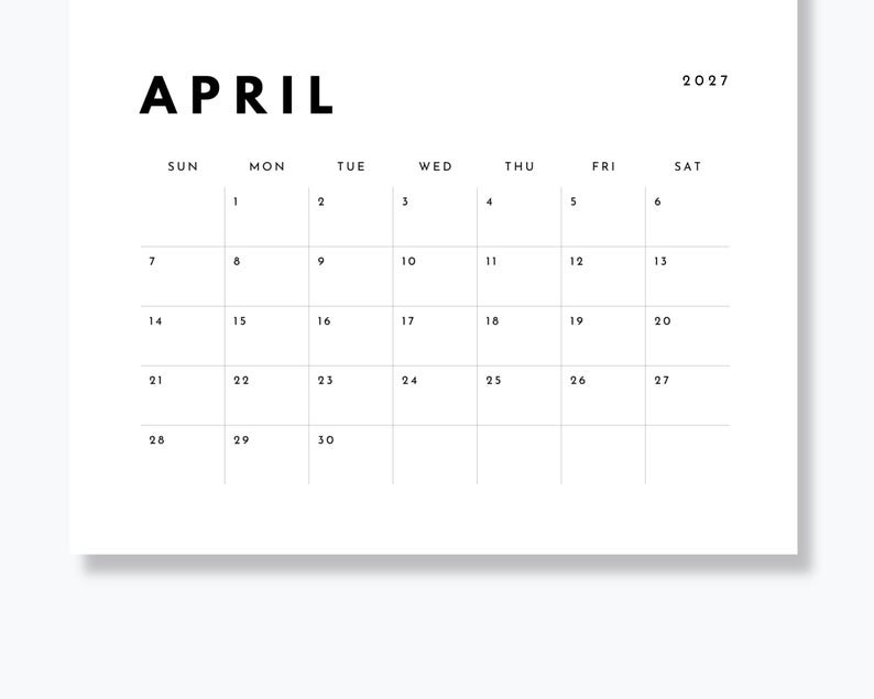 May include: A white wall calendar page for April 2027 with black sans-serif text. The month name APRIL is in large bold letters at the top left, with the year 2027 at the top right. A grid displays the days of the week and dates from 1 to 30.