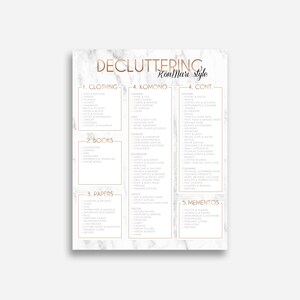 May include: A white and gray marble background with a gold outline around a list of categories for decluttering using the KonMari method. The categories include clothing, books, papers, Komono, and mementos.
