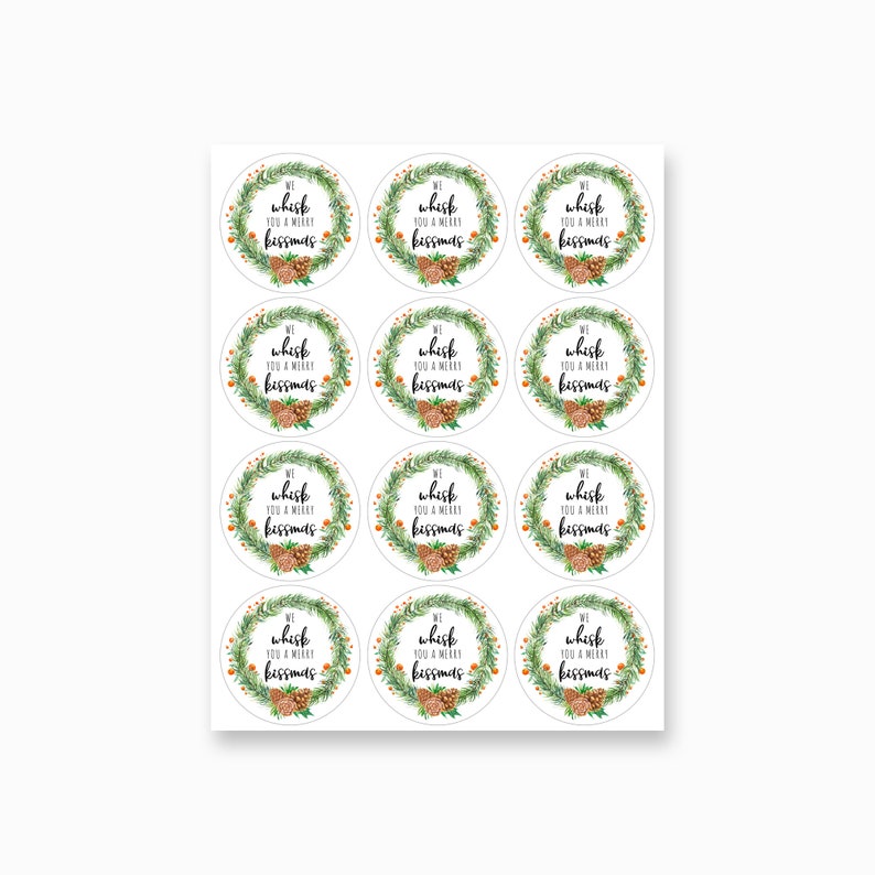 May include: Twelve round, white gift tags with a green wreath design and the text "We whisk you a merry kissmas".