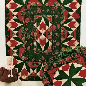 May include: A collection of Christmas-themed quilts and pillows. The quilts feature a repeating pattern of red, green, and white geometric shapes on a dark green floral background. A doll in a red coat and white bonnet is also present.
