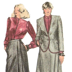 May include: Two women wearing skirts and blouses. The woman on the left is wearing a burgundy blouse with a black skirt. The woman on the right is wearing a gray jacket over a burgundy blouse and a gray skirt.