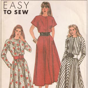 May include: Simplicity sewing pattern featuring three dress designs. The dresses include a floral print, a solid red dress, and a black and white striped dress. The pattern is labeled "Easy to Sew."