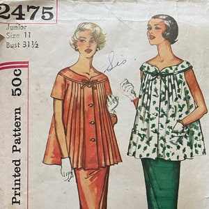 May include: Simplicity Printed Pattern 500c, a vintage sewing pattern for a dress with a pleated bodice and a skirt. The pattern is for Junior size 11, bust 31 1/2. The pattern shows two different styles of the dress, one with a solid orange bodice and skirt, and the other with a white bodice and green skirt with a floral print.