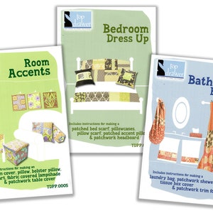 May include: Three colorful brochures with patchwork designs for home decor projects. The brochures are titled "Room Accents", "Bedroom Dress Up", and "Bathroom Basics". Each brochure features a different room setting and includes instructions for making various items, such as pillows, a bed scarf, a shower curtain, and a table cover.