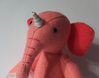 Elephant in pink sewn from felt with unicorn and tutu