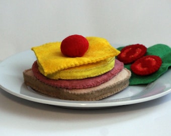 Toast Hawaii with a slice each of pineapple, cheese and ham with cherry hand-sewn from felt for the children's kitchen, play kitchen shop