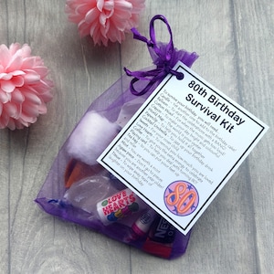 May include: A purple organza bag filled with small gifts and a white card with the text "80th Birthday Survival Kit" and a list of items needed to survive the birthday. The card also has a large red circle with the number 80 inside.