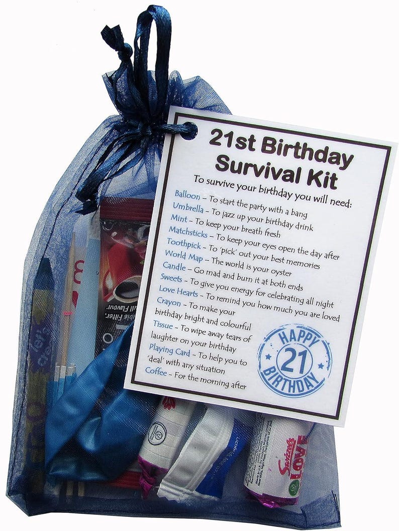 May include: A blue and white gift bag filled with a 21st birthday survival kit. The bag contains a balloon, a candle, a pack of matches, a world map, a pack of love hearts, a crayon, a tissue, a playing card, and a coffee packet. The bag has a tag attached that reads "21st Birthday Survival Kit" and lists the contents of the bag with a description of how to use each item.