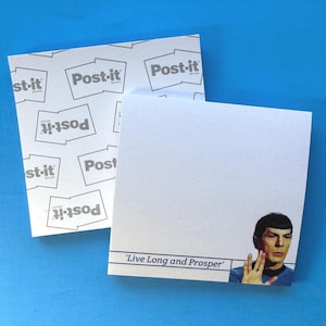 May include: Two white Post-it note pads. One pad has a repeating Post-it logo pattern. The other pad has a picture of Spock from Star Trek and the phrase "Live Long and Prosper". The background is blue.