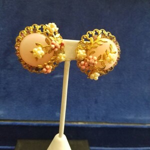 A vintage pair of clip-ons 1960s with rhinestone trim and accent pieces set on goldtone.  Quite pretty.  Origin unknown;however, antique.