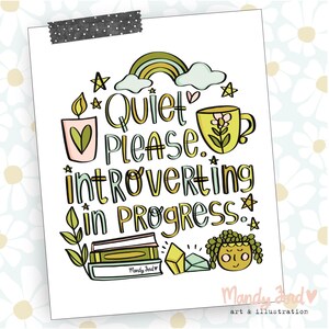 May include: A colorful illustration with the text "Quiet Please. Introverting in Progress."  The illustration includes a rainbow, a candle, a cup of tea, a stack of books, a crystal, and a plant. The text "Mandy and" is at the bottom of the illustration.